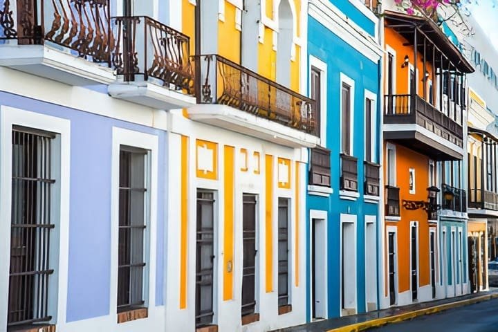 Colorful colonial buildings with wrought iron balconies lining a street in Old San Juan, Puerto Rico